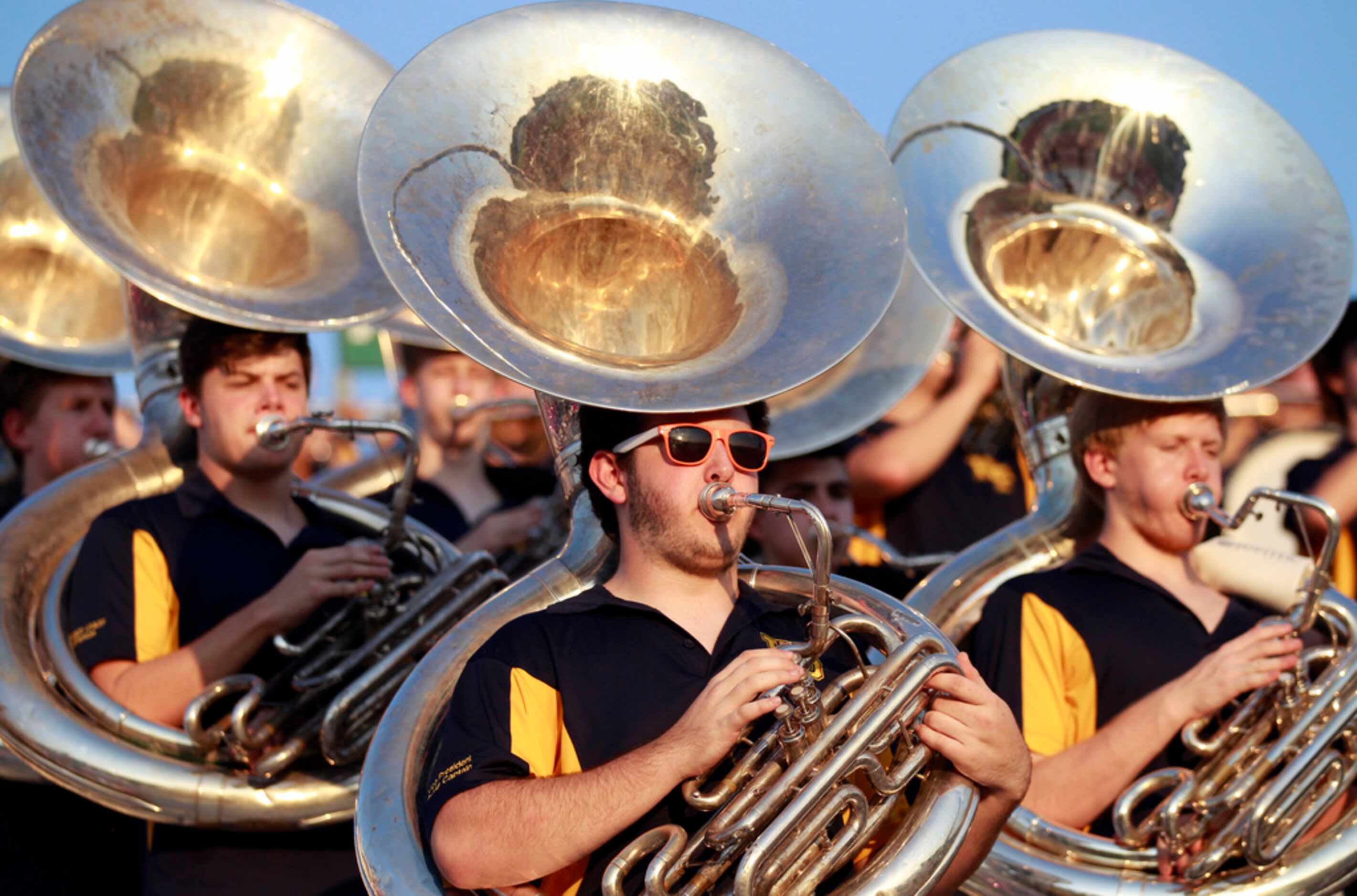 Tuba player Bobby Schiff, a senior, in sunglasses, practices before the start of their high...