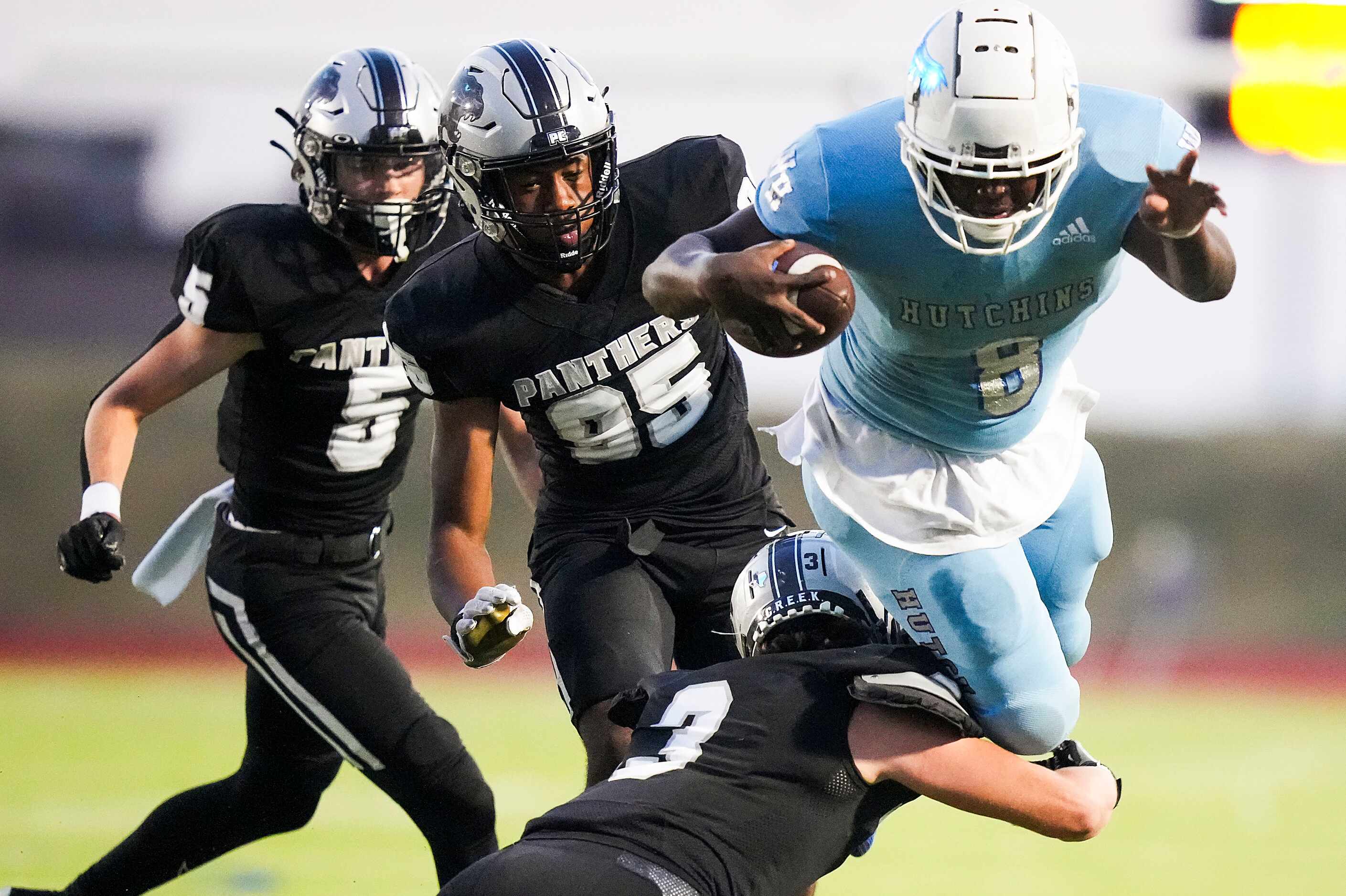 Wilmer-Hutchins running back Jacob Cummings (8) is brought down by Panther Creek’s Seth...