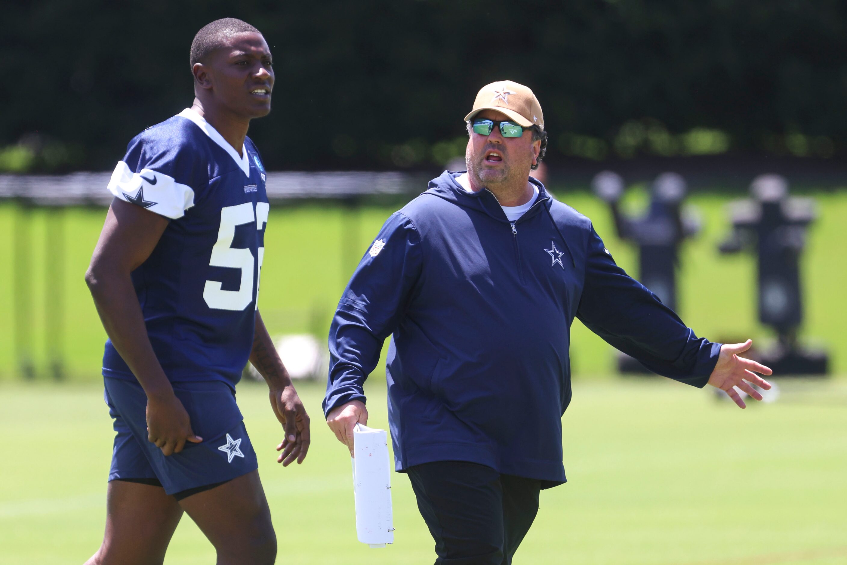 Dallas Cowboys defensive run game coordinator Paul Guenther instructs linebacker Byron...