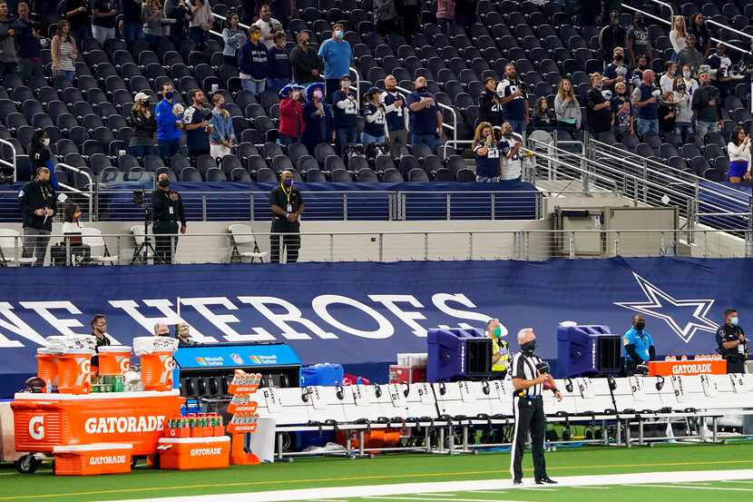 The Arizona Cardinals sideline sits empty during the national anthem before an NFL football...