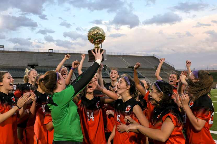 The Rockwall Lady Jackets hold up their trophy after defeating Duncanville, 1-0 in the 6A...