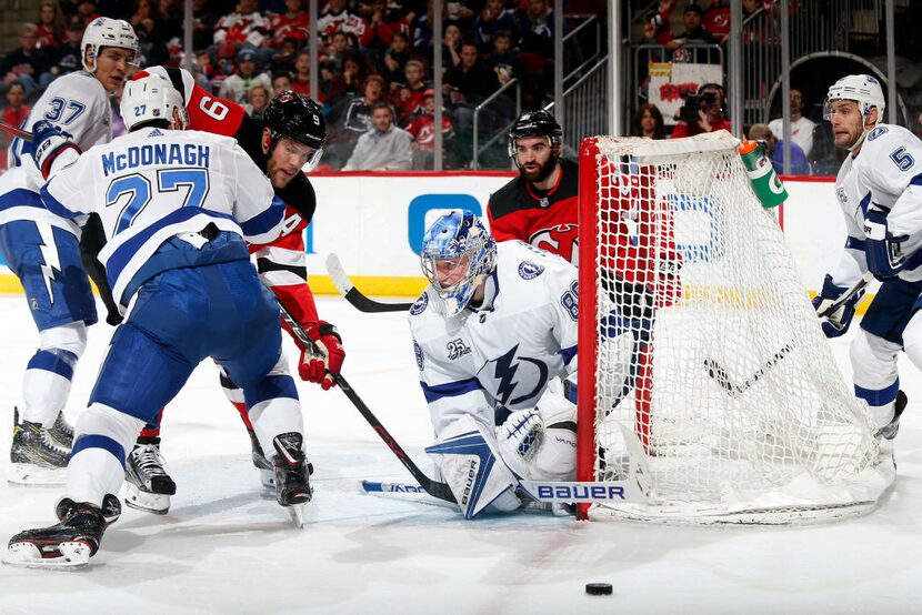 NEWARK, NJ - MARCH 24: Taylor Hall #9 of the New Jersey Devils battles for the puck with...