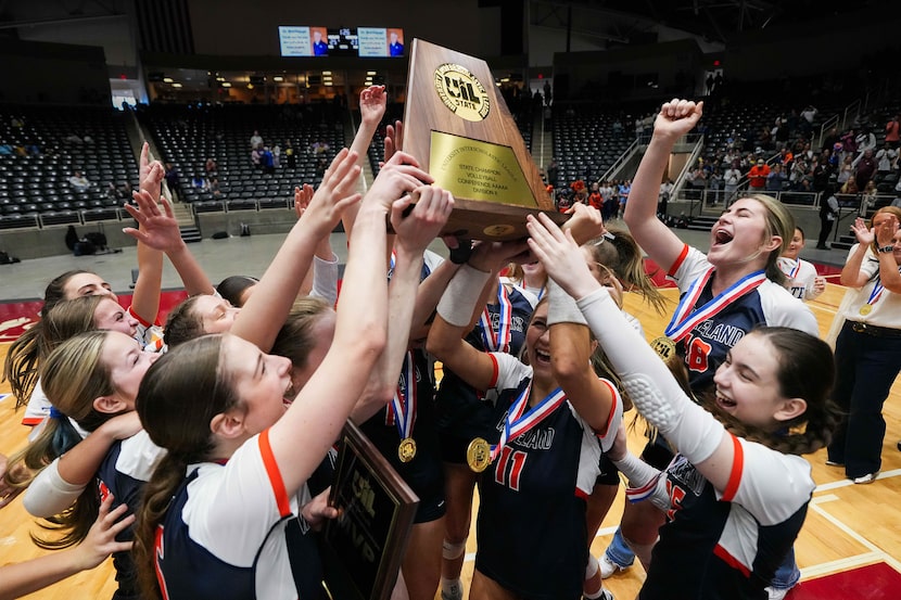 Frisco Wakeland players celebrate with the championship trophy after their victory over...