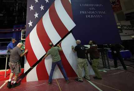 Workers install the set for the first presidential debate at Hofstra University.