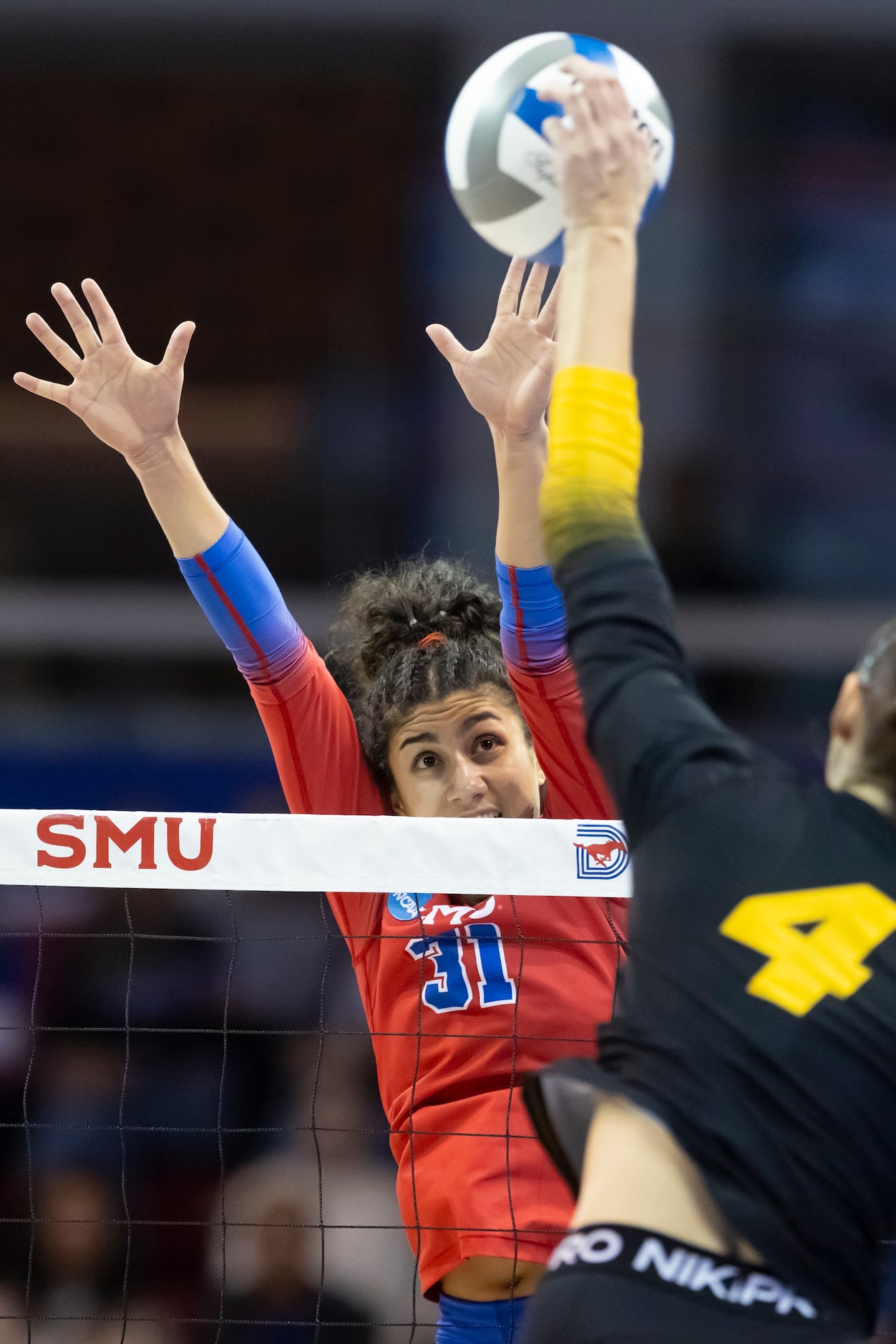 Missouri’s Jordan Iliff (4) spikes the ball as SMU’s Maya Tabron (31) attempts to block...