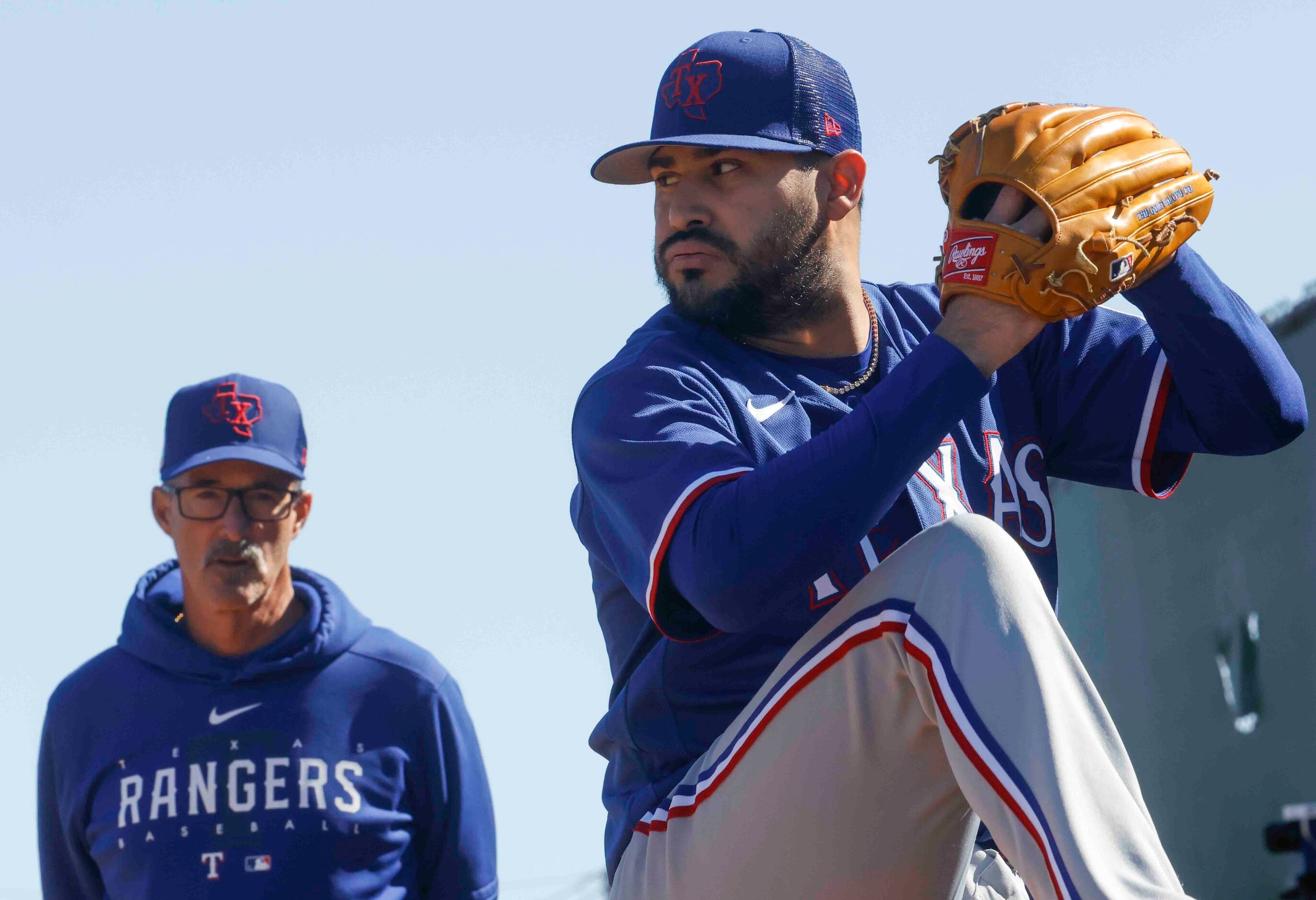 Texas Rangers pitching coach Mike Maddux, left, observes Texas Rangers left handed pitcher...