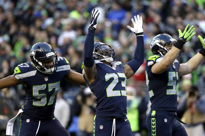 Seattle Seahawks strong safety Jeron Johnson (23) celebrates his tackle of San Francisco...