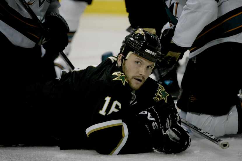 Dallas Stars center Sean Avery lays on the ice after coming up short with a goal attempt...