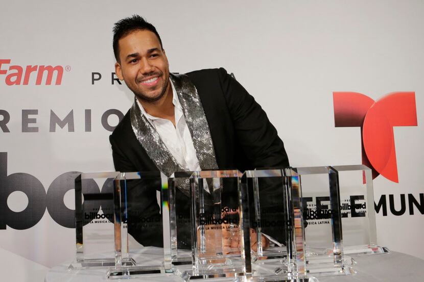 Romeo Santos poses with his 10 award during the Latin Billboard Awards Thursday, April 30,...