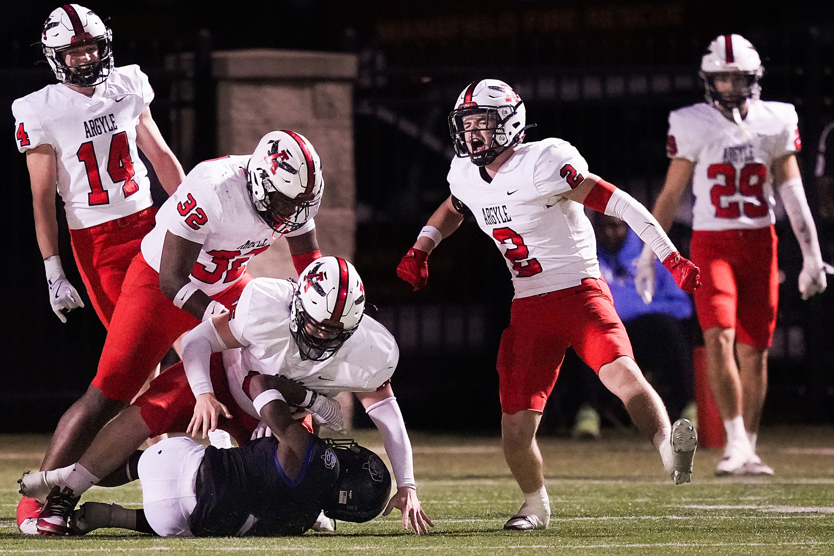 Argyle defensive back Garrett Westrom (2) celebrates after defensive lineman Tyler Cobb (66)...