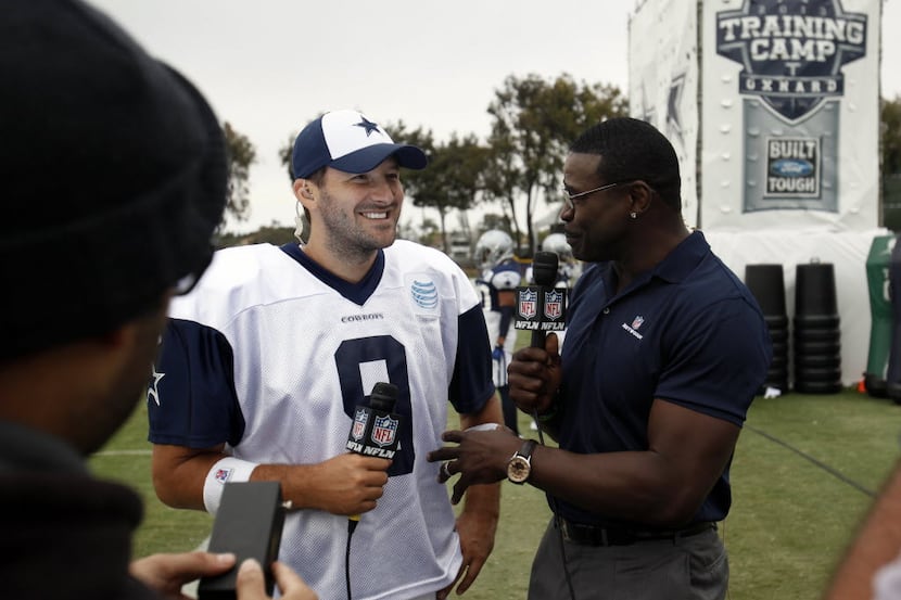 Former Dallas Cowboys player Michael Irvin talks with Dallas Cowboys quarterback Tony Romo...
