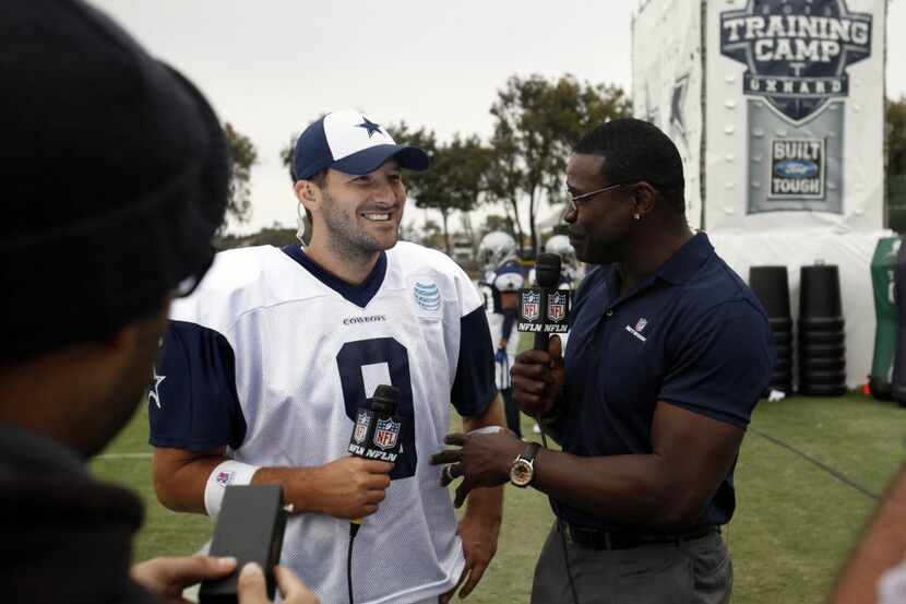 Former Dallas Cowboys player Michael Irvin talks with Dallas Cowboys quarterback Tony Romo...