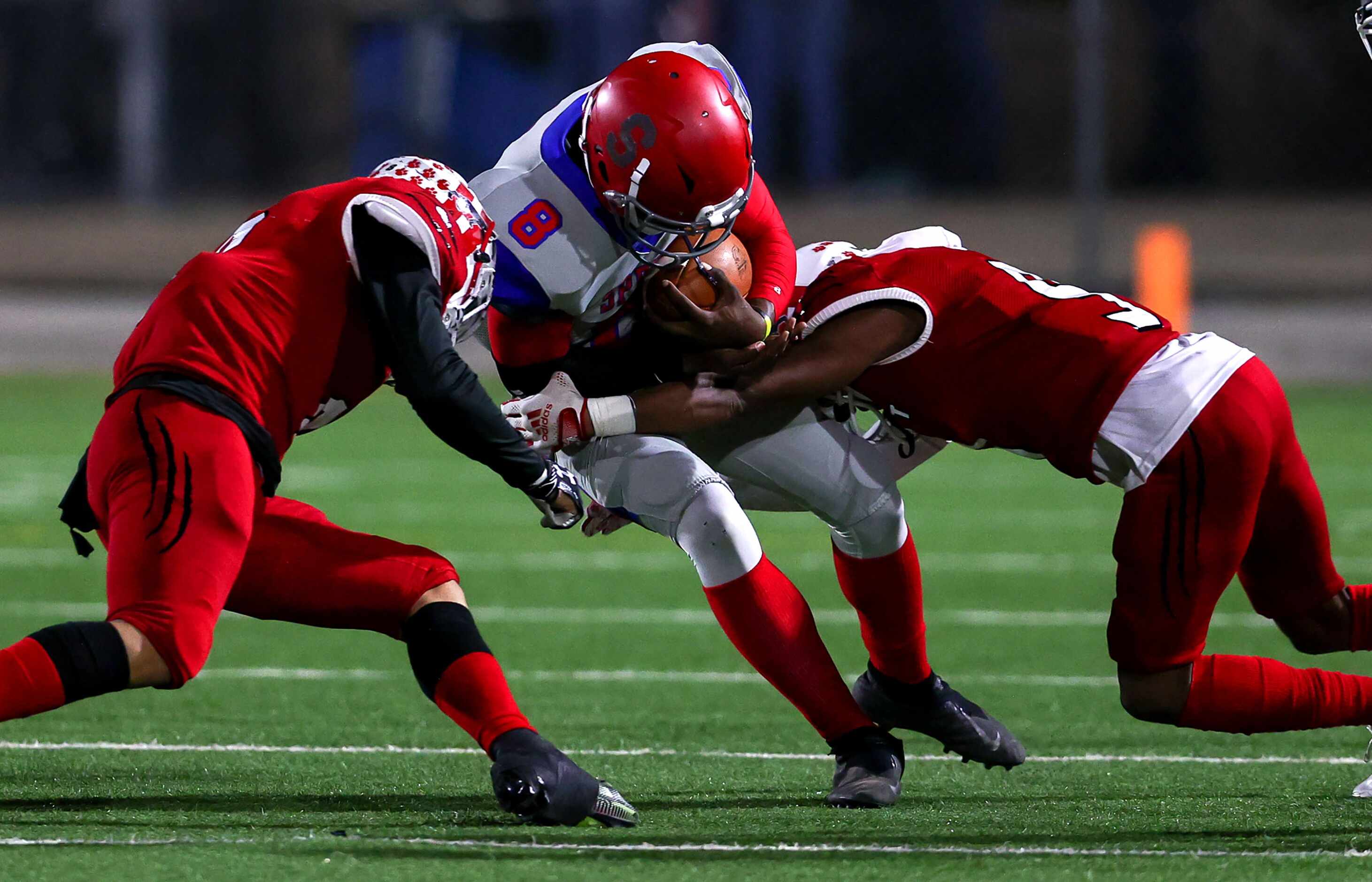 Spruce quarterback Kelvin Jones (8) gets brought down by Hillcrest  linebacker Brady Gibson...