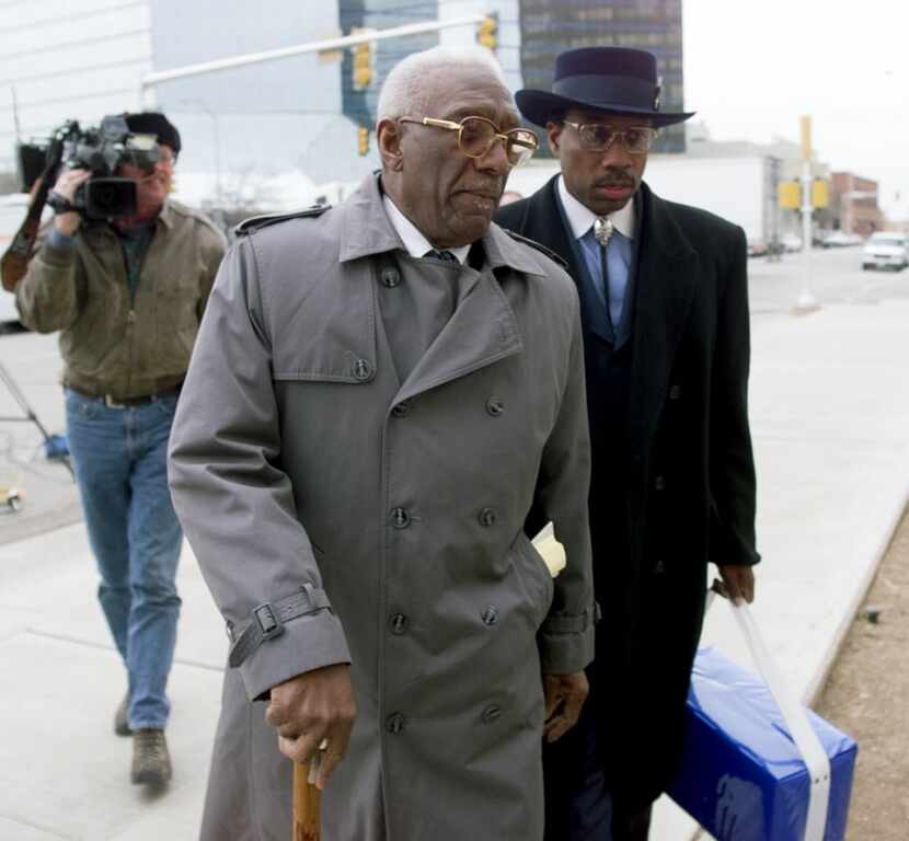 Former Dallas City Council member Al Lipscomb walks with John Wiley Price outside a federal...