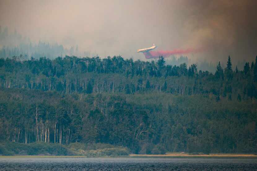 A tanker drops retardant while battling the Shovel Lake wildfire near Fraser Lake, British...
