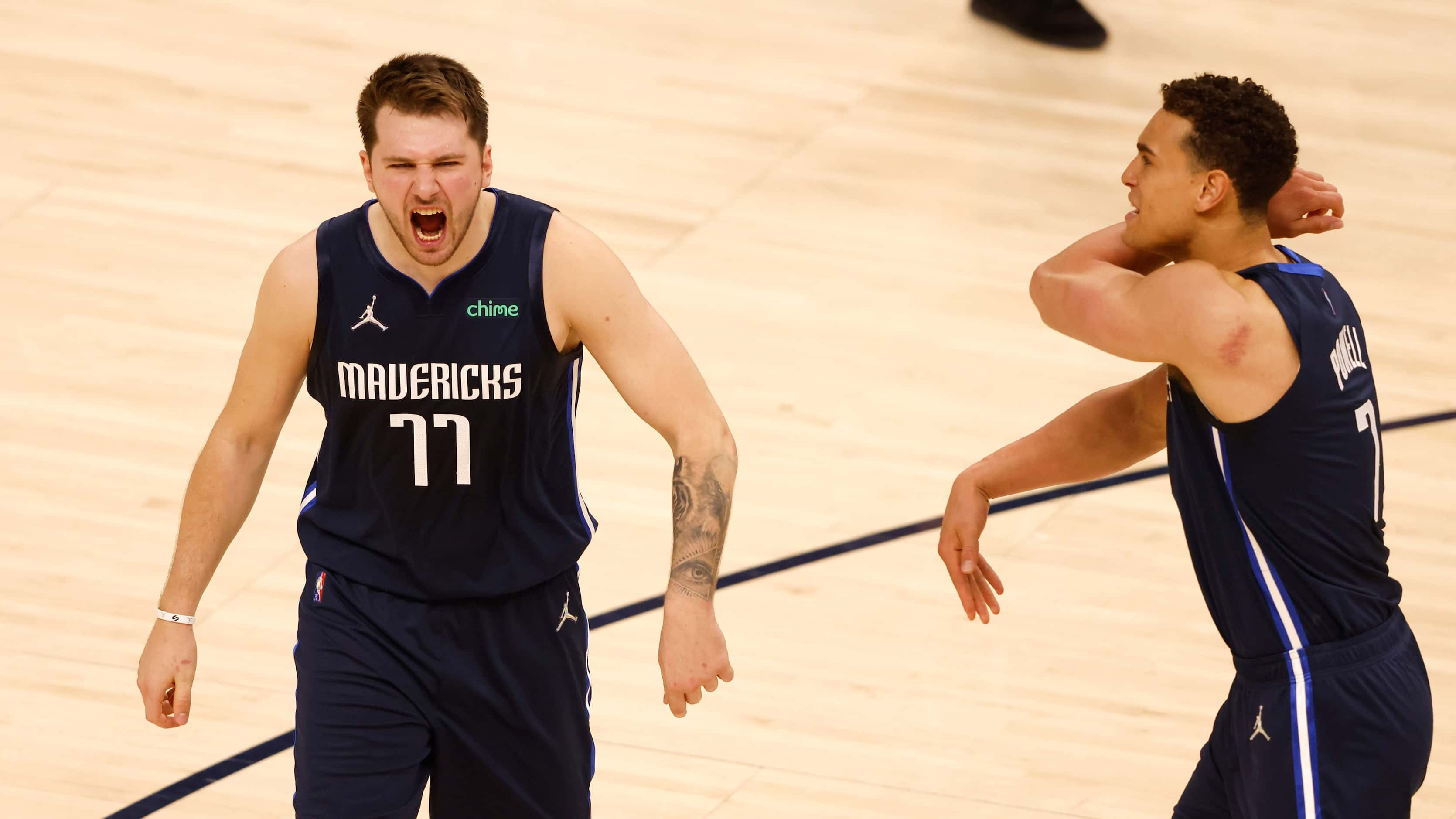 Dallas Mavericks guard Luka Doncic (77) celebrates with Dallas Mavericks center Dwight...