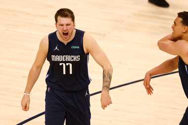 Dallas Mavericks guard Luka Doncic (77) celebrates with Dallas Mavericks center Dwight...