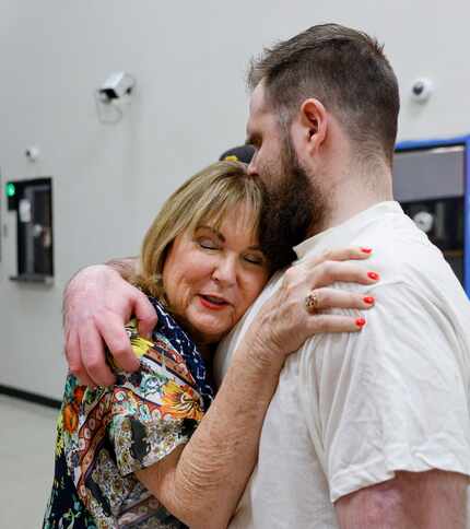 Chad Williamson (right) kisses his mother Sheila Williamson after being released from the...