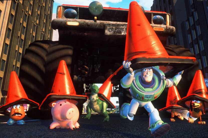 Using orange cones for camouflage, Buzz Lightyear leads the toys from Andy's room on a...