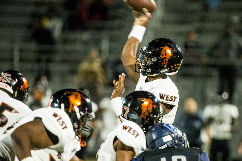 West Mesquite's quarterback Neal Johnson (13) makes a pass during a football game between...