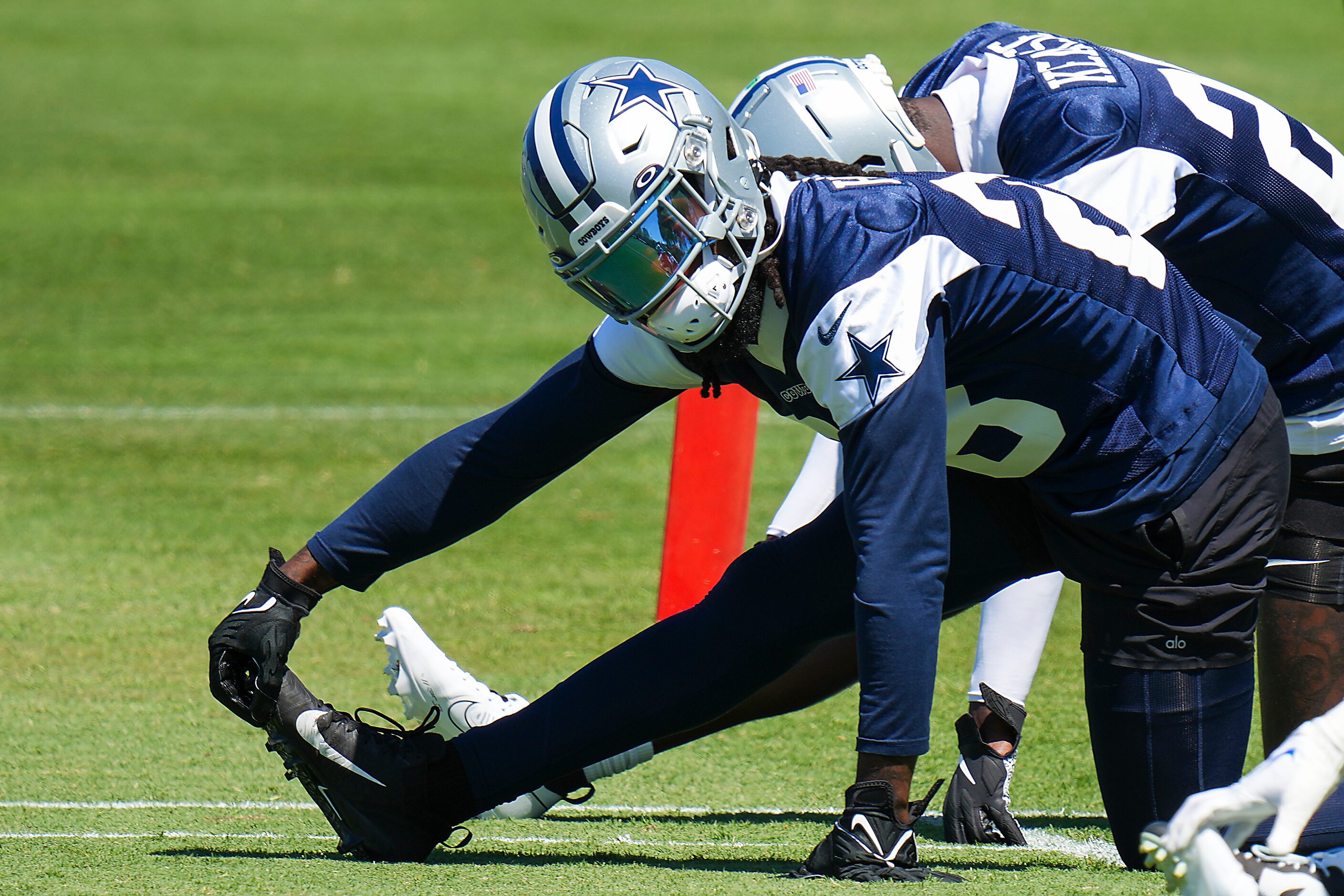 Dallas Cowboys free safety Malik Hooker (28) stretches with teammates during a training camp...