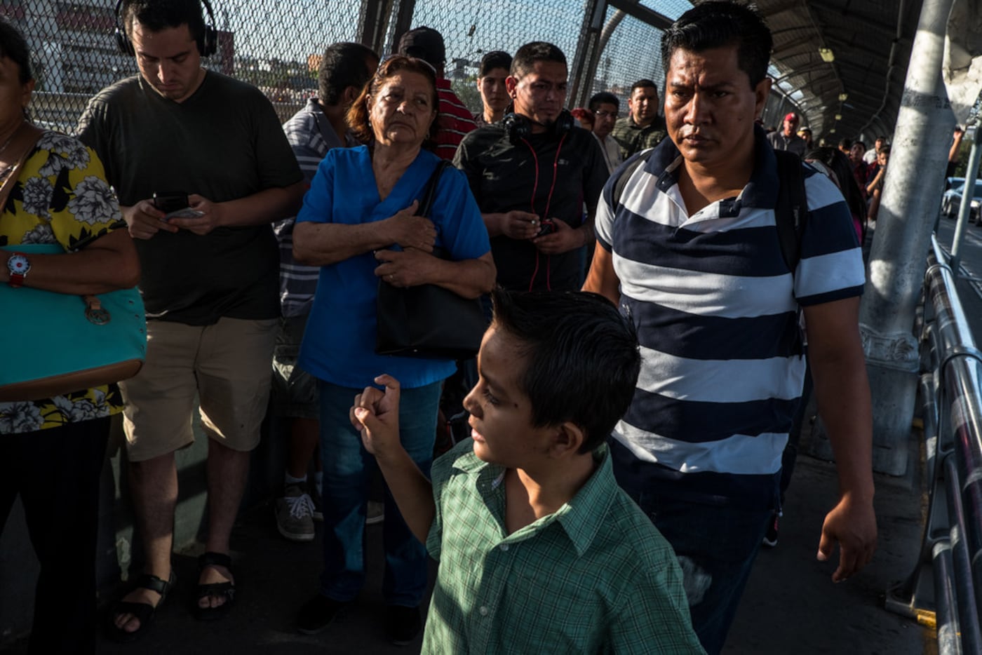 Cristopher Yovani Monjel, 7, left, is followed by his father Edgar, 34, right, as they walk...