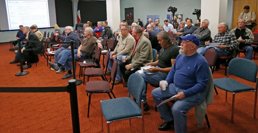 People in the audience attend the Board of Trustees meeting at Dallas Police and Fire...