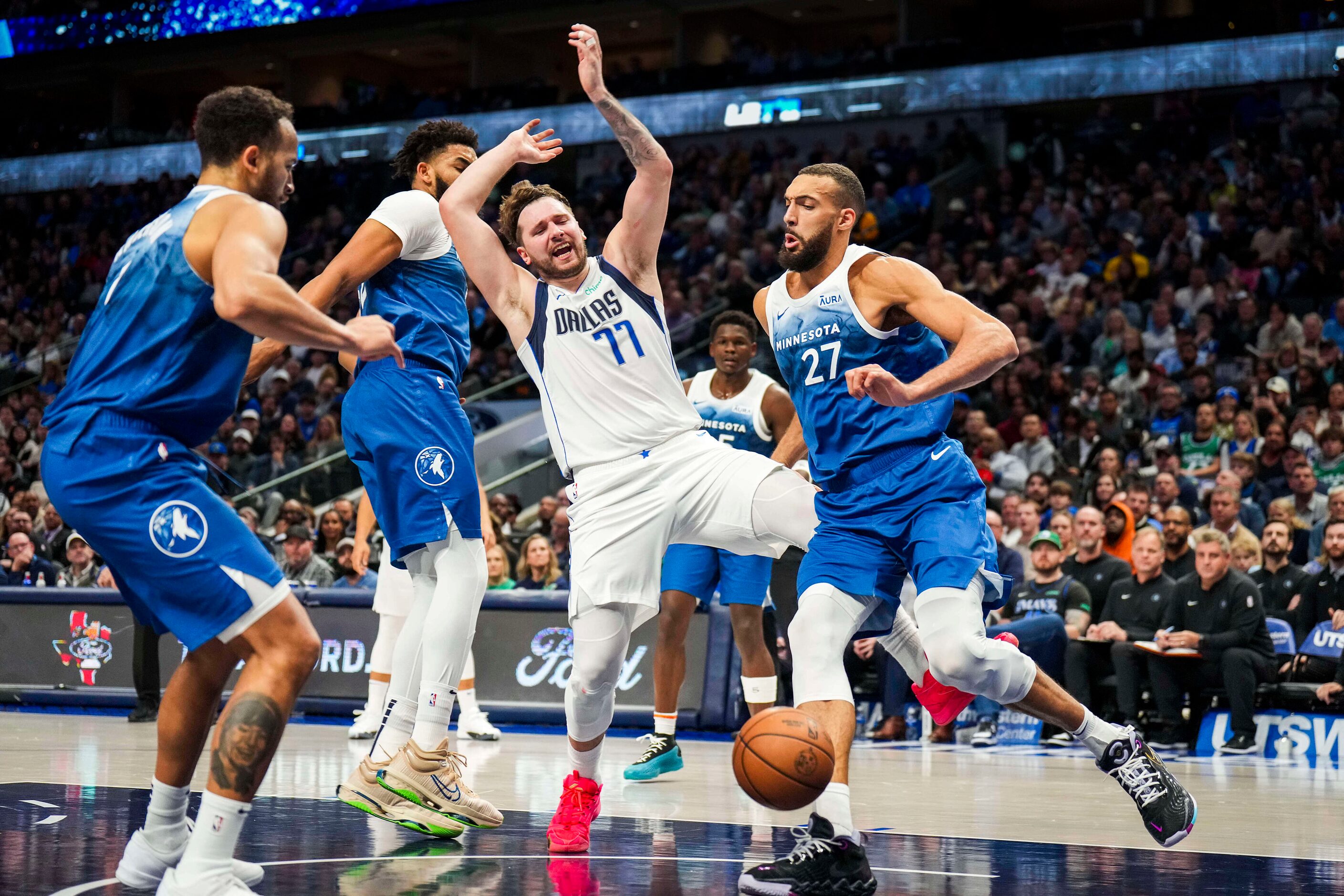 Dallas Mavericks guard Luka Doncic (77) is fouled by Minnesota Timberwolves center...