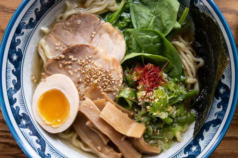 The signature bowl at Hinodeya Ramen and Bar, featuring a dashi broth topped with chashu pork