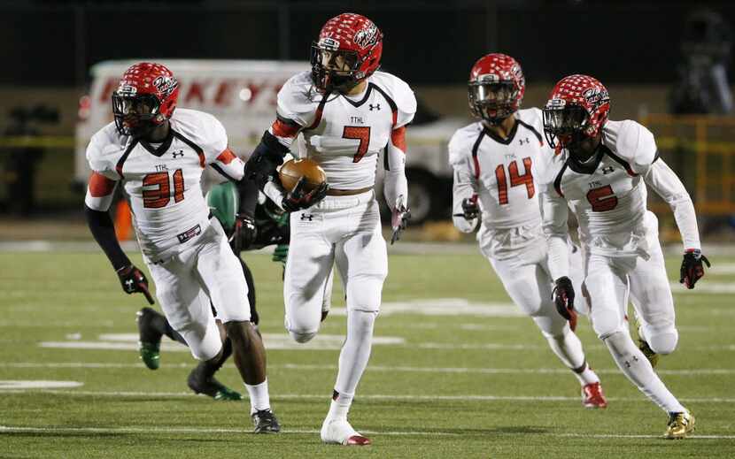 Cedar Hill linebacker Dimitri Moore (7) runs with a recovered ball after safety Kolbi McGary...