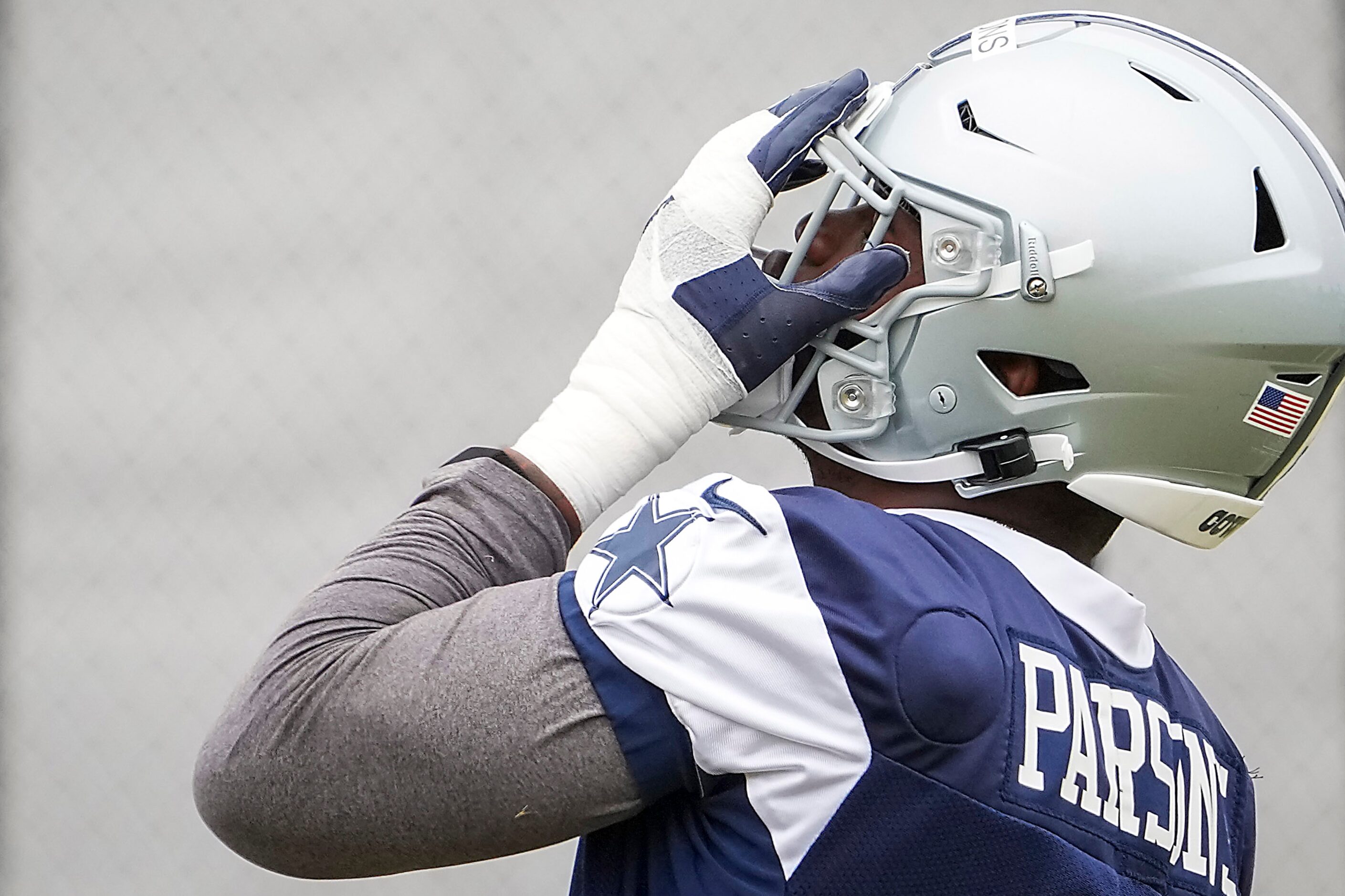 Dallas Cowboys linebacker Micah Parsons (11) adjusts his helmet during a practice at...