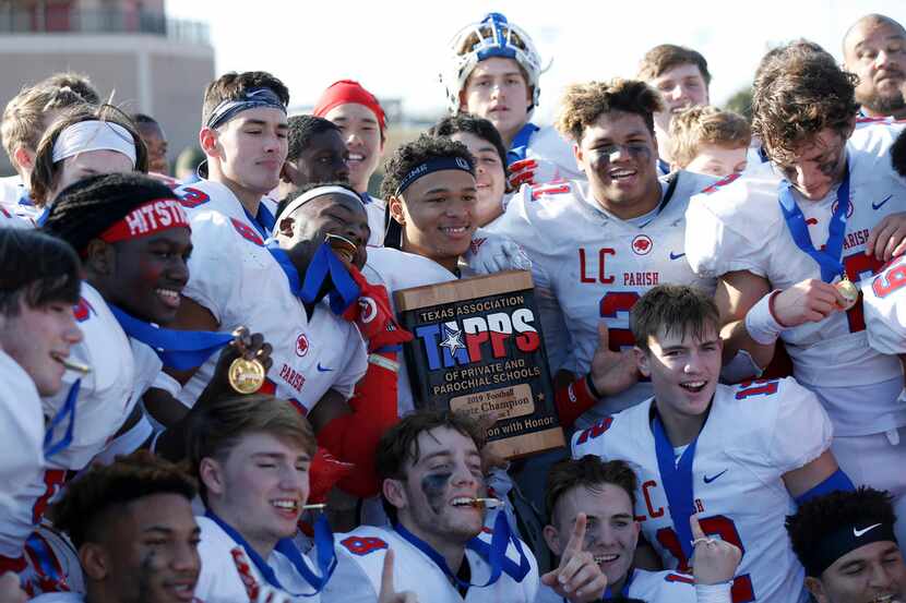 Parish Episcopal's Christian Benson (23) holds up the trophy as he poses for a photo with...