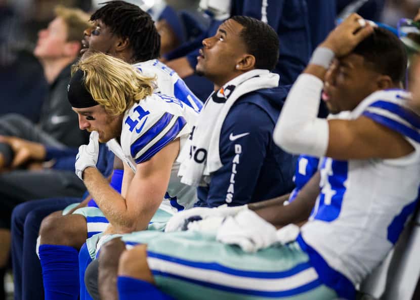 Dallas Cowboys wide receiver Cole Beasley (11), left, and Terrance Williams (83) sit on the...