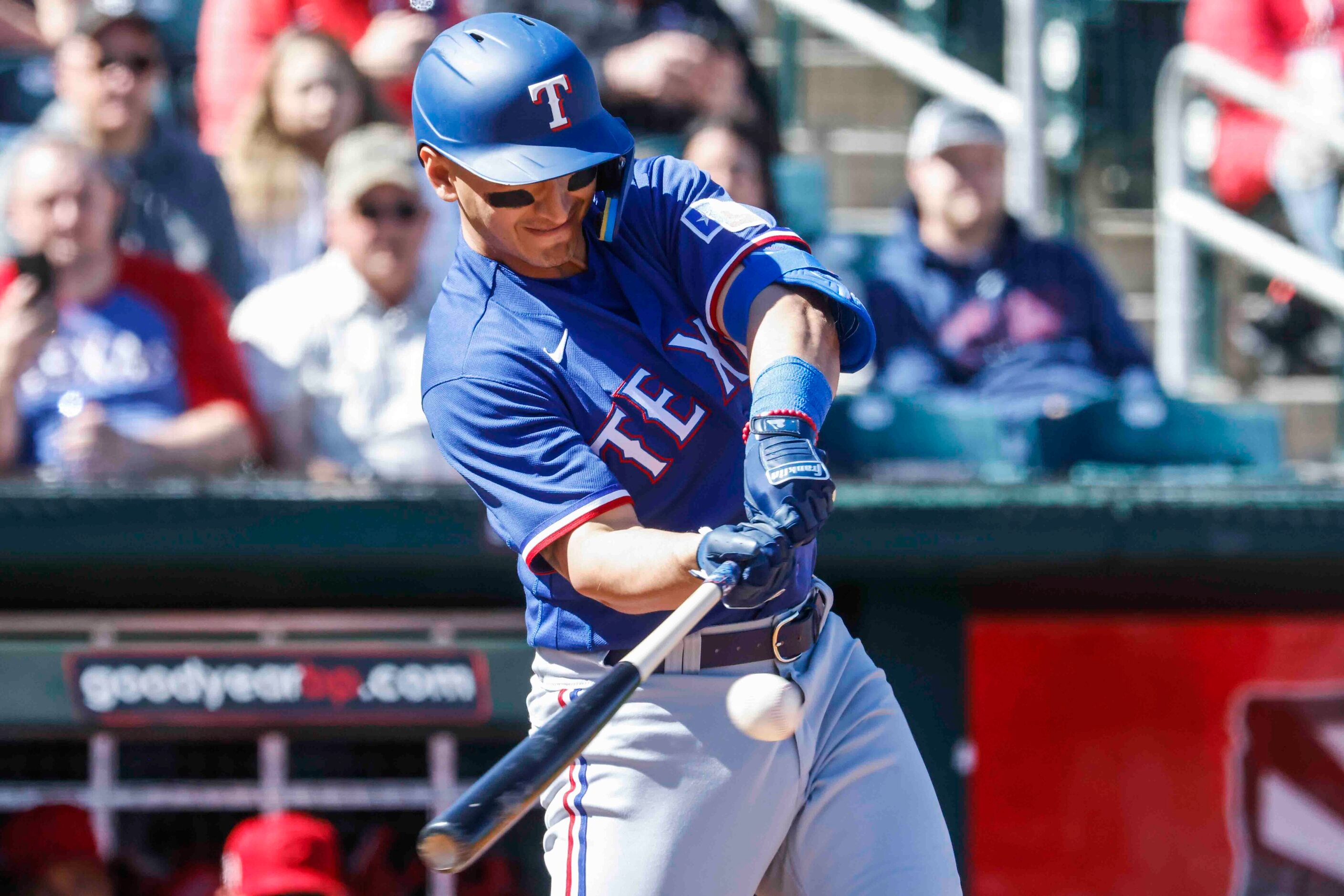 Texas Rangers Mark Mathias gets a hit during the second inning of a spring training game...