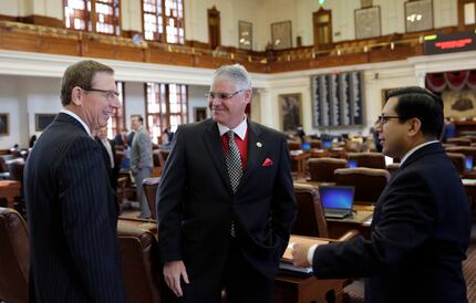 Rep. Dan Huberty (center), R-Houston, conferred with Rep. Byron Cook (left), R-Corsicana,...