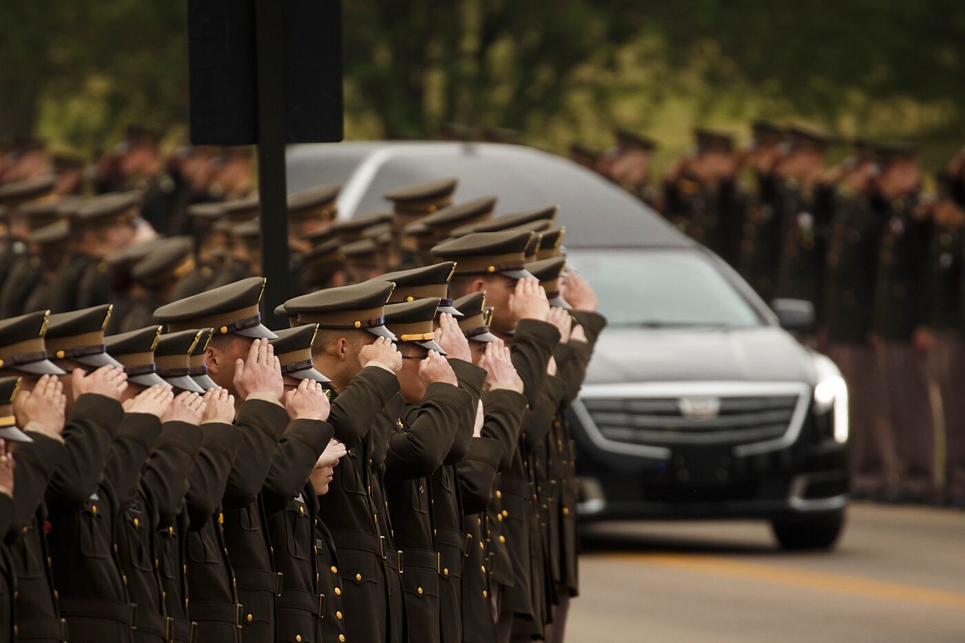 The hearse carrying former first lady Barbara Bush passes near members of the Texas A&M...