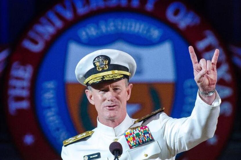 
Naval Adm. Bill McRaven, a UT alum, does the Longhorns’ Hook ‘em Horns hand signal during...