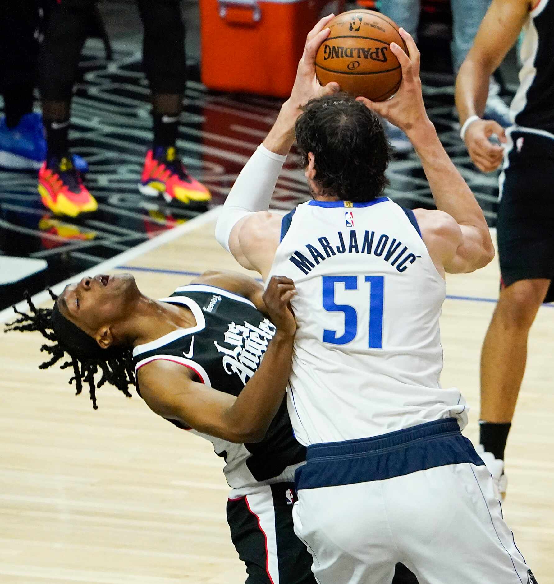 Dallas Mavericks center Boban Marjanovic (51) fouls LA Clippers guard Terance Mann (14) as...