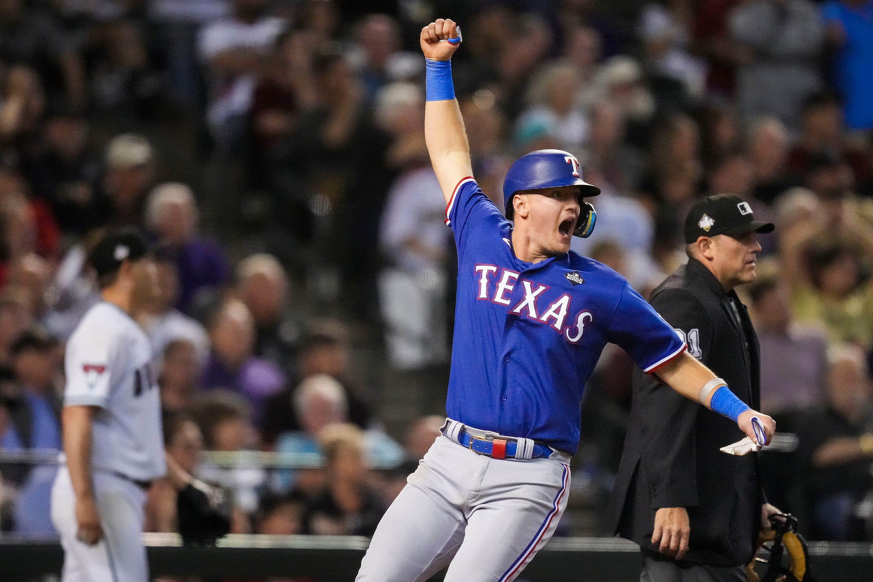 Texas Rangers’ Josh Jung celebrates scoring on a single hit by Jonah Heim during the ninth...