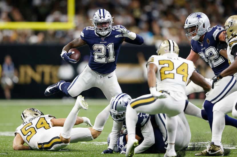 Dallas Cowboys running back Ezekiel Elliott (21) leaps over New Orleans Saints outside...