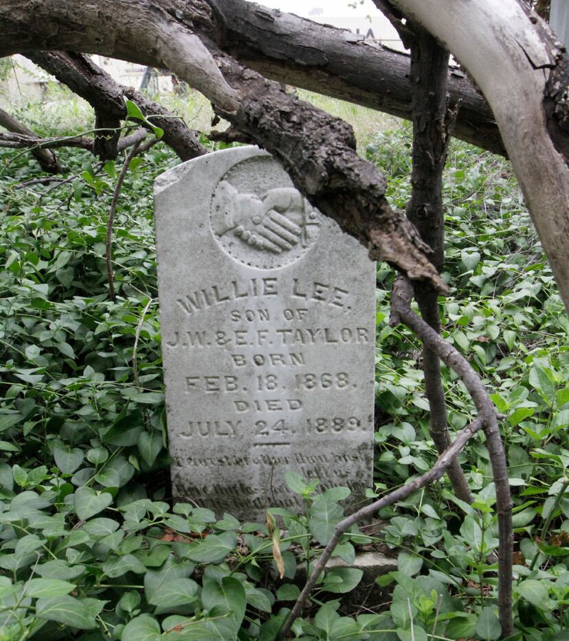 Another tombstone hidden beneath the greenery at the Mooneyham Sparkman Cemetery in...