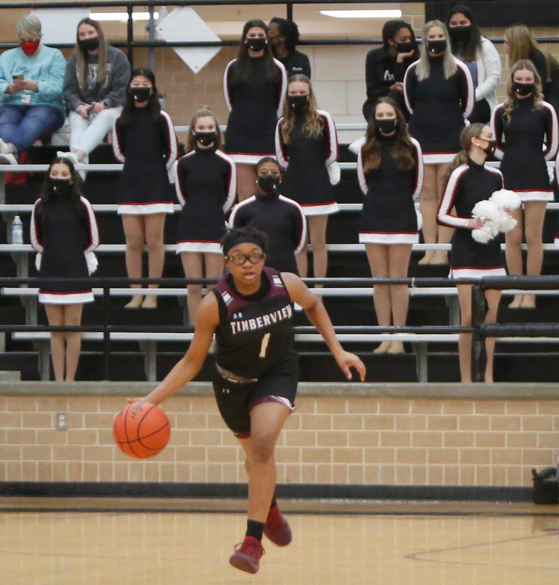 Mansfield Timberview's Tamaiya Mims (1) dribbles the ball toward mid-court during first half...
