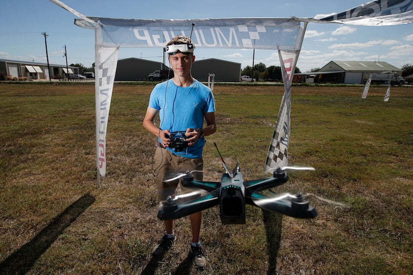 Professional drone pilot Alex Vanover poses for a photo with one of his racing drones at the...
