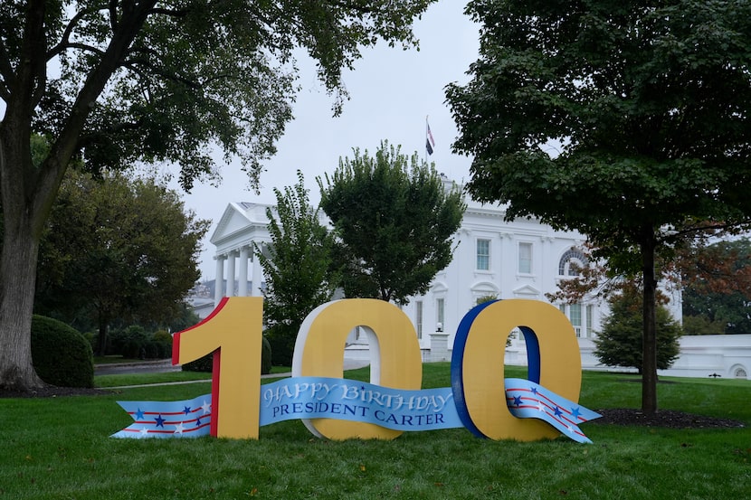 A sign wishing former President Jimmy Carter a happy 100th birthday sits on the North Lawn...