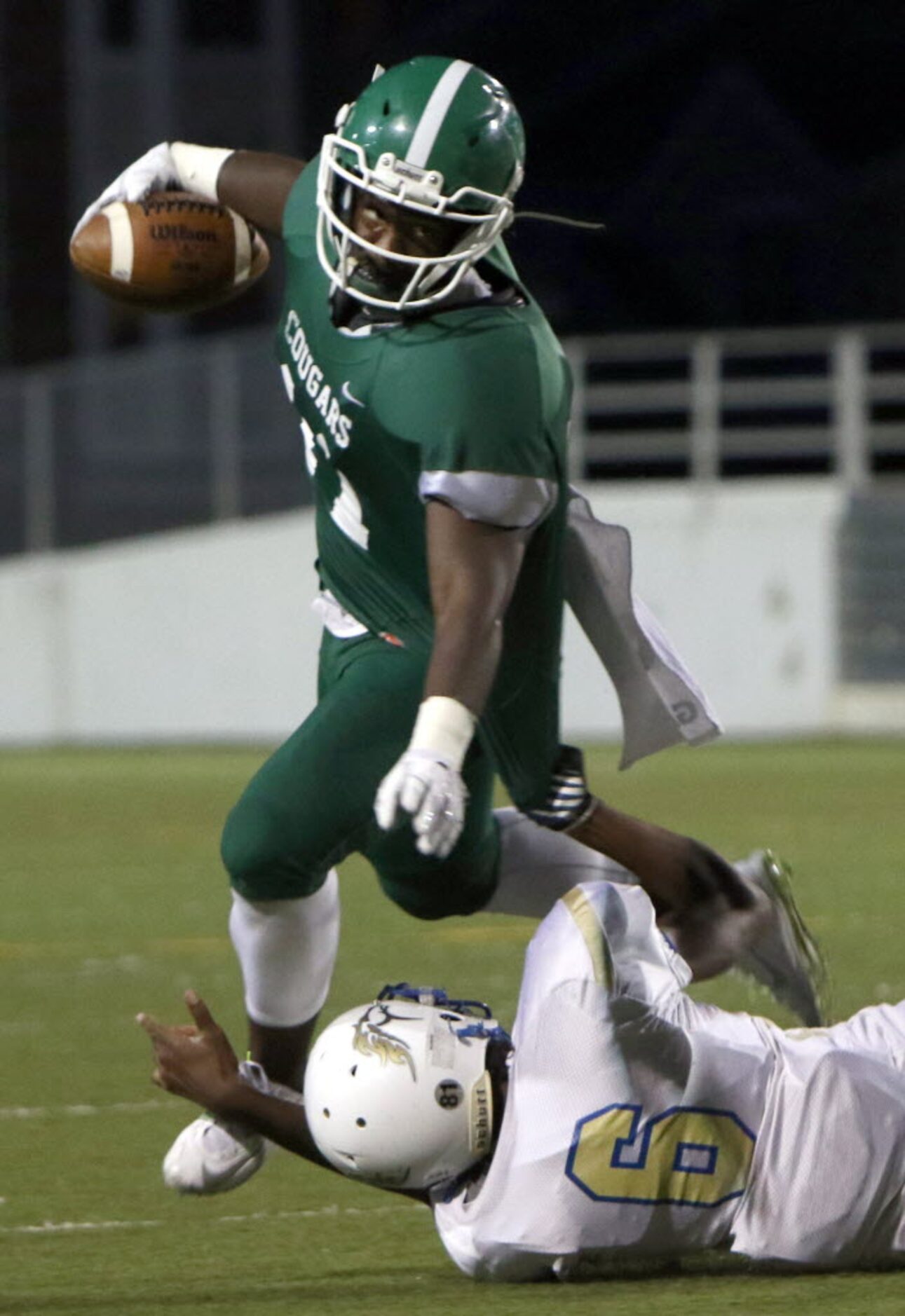 Bryan Adams receiver Keylhin Cheeley (11) looks for running room as Conrad defensive back...