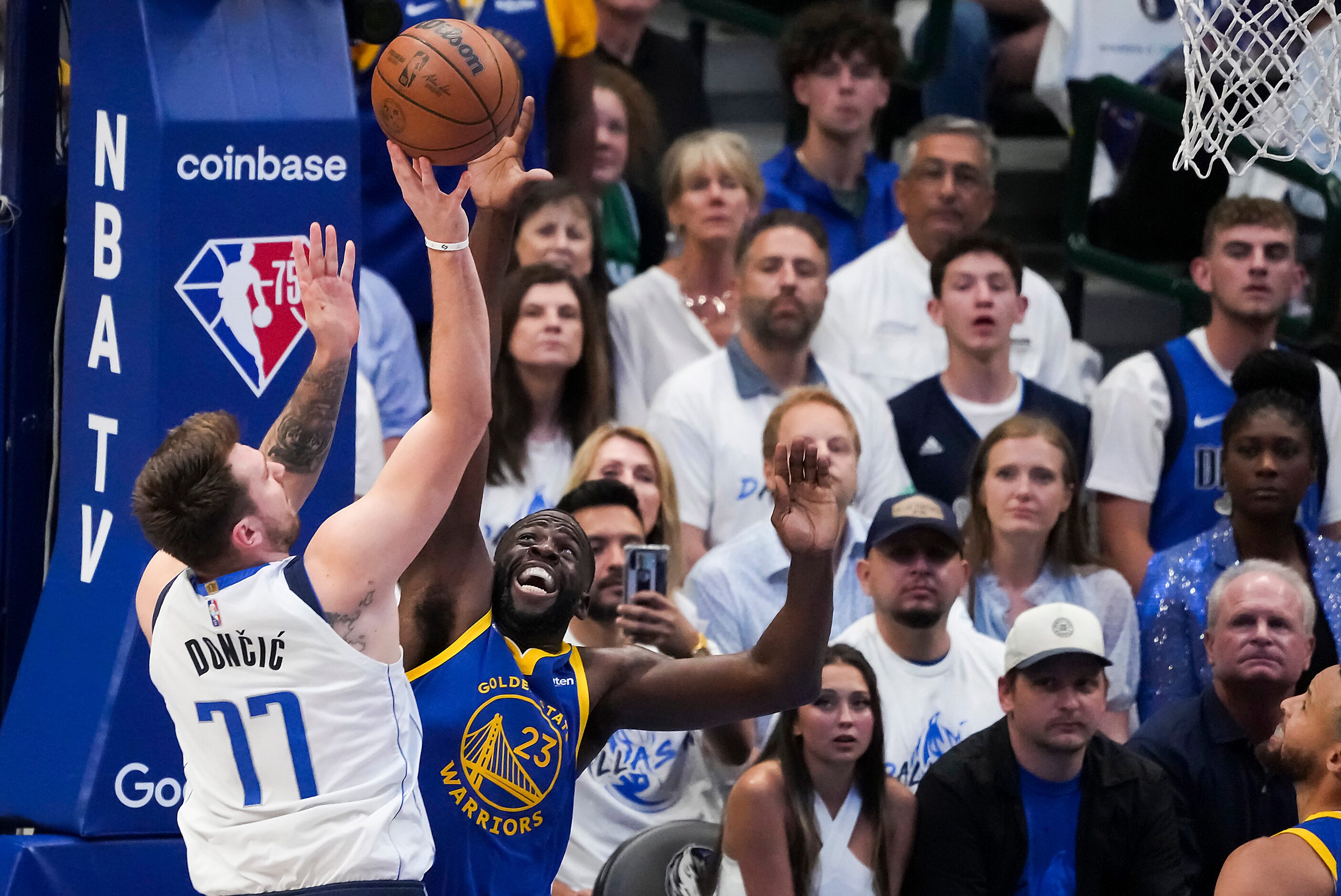 Dallas Mavericks guard Luka Doncic (77) shoots over Golden State Warriors forward Draymond...