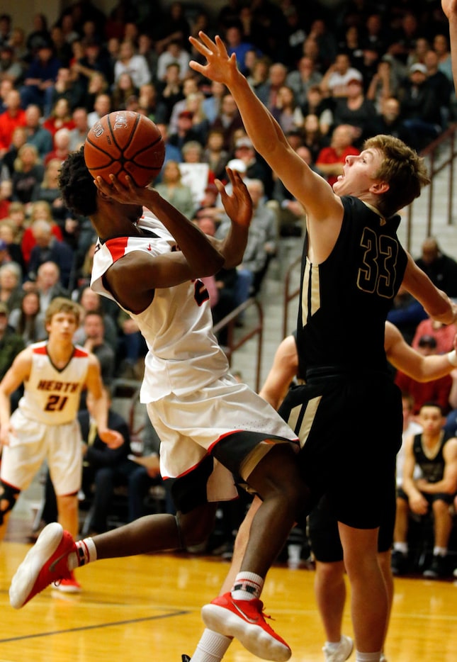 Rockwall Heath guard Brent Clark (2) tries to get a shot over Jesuit guard Anthony Hollerich...