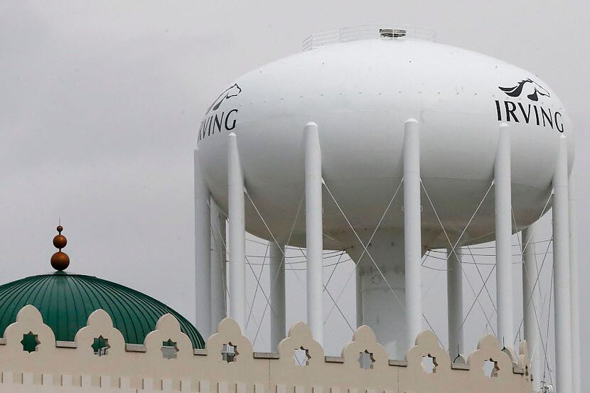 A water tower with the City of Irving logo looms over the Islamic Center of Irving at 2555...