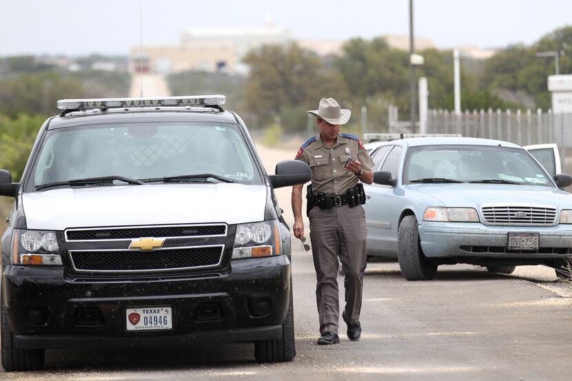 Texas Department of Public Safety Trooper Shawn Baxter waits to advise the media at the...