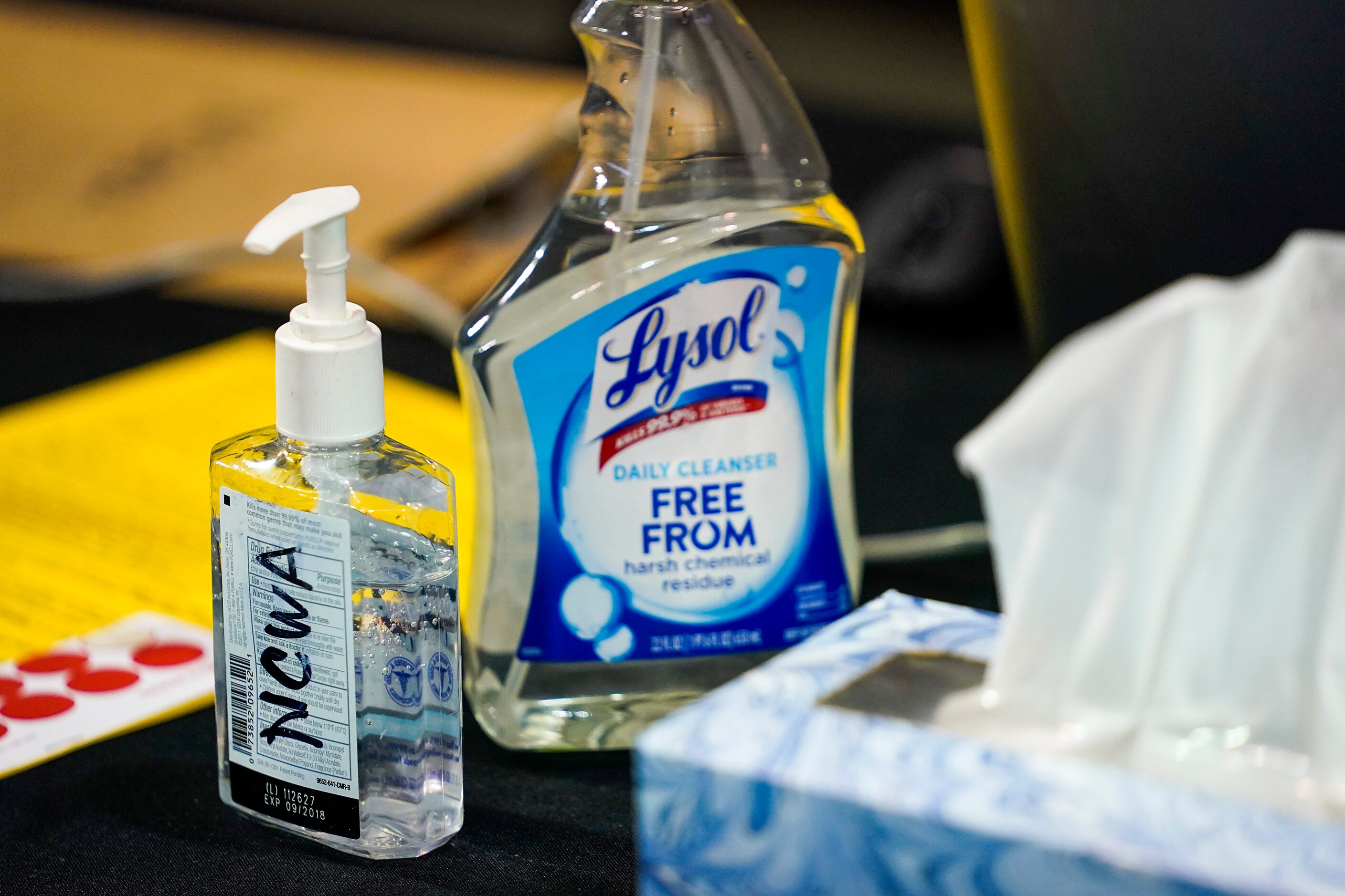 Bottles of hand sanitizer and disinfectant rest on a scorers table during the NCWA national...